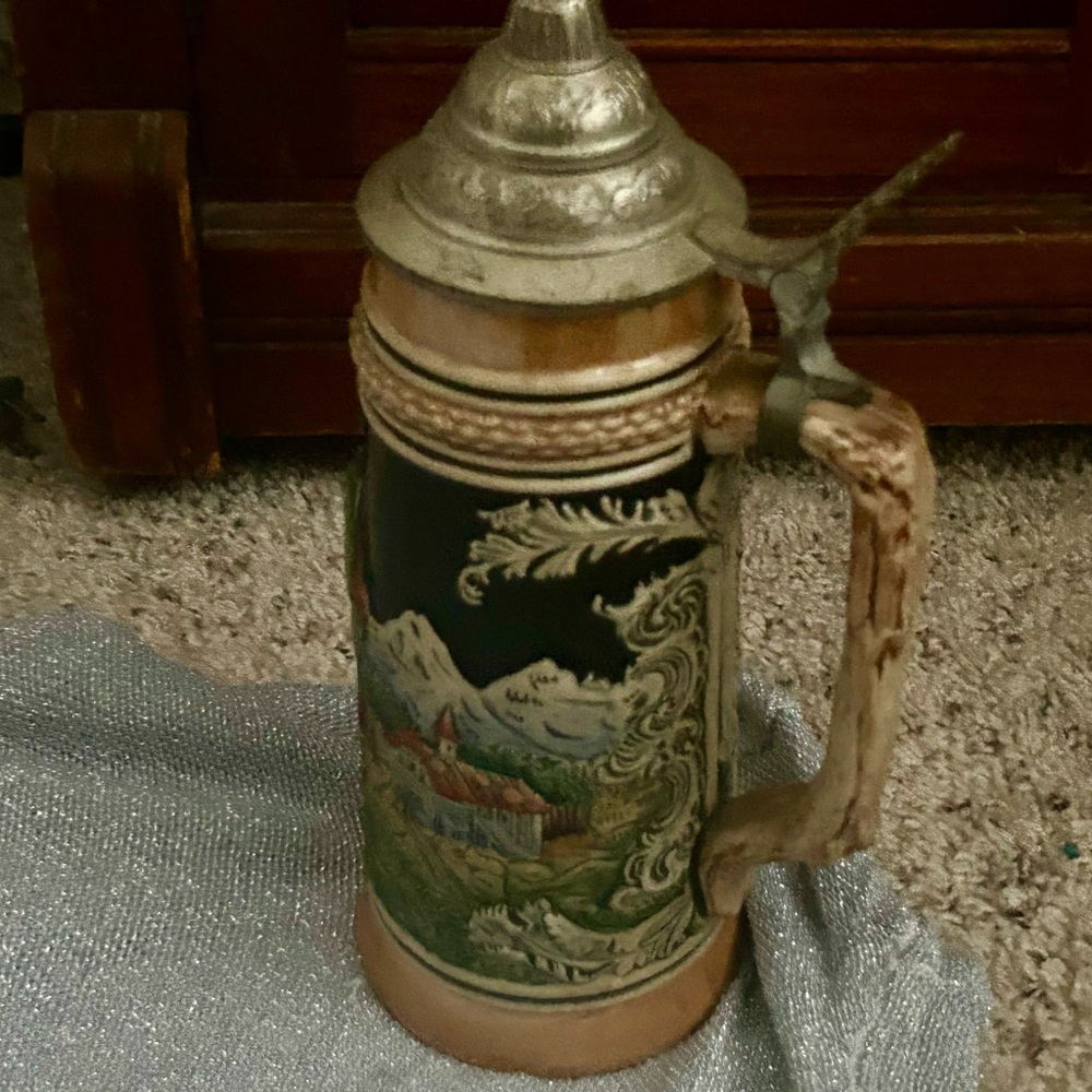 Collectible Beer stein ceramic with silver lid, painted scenes.